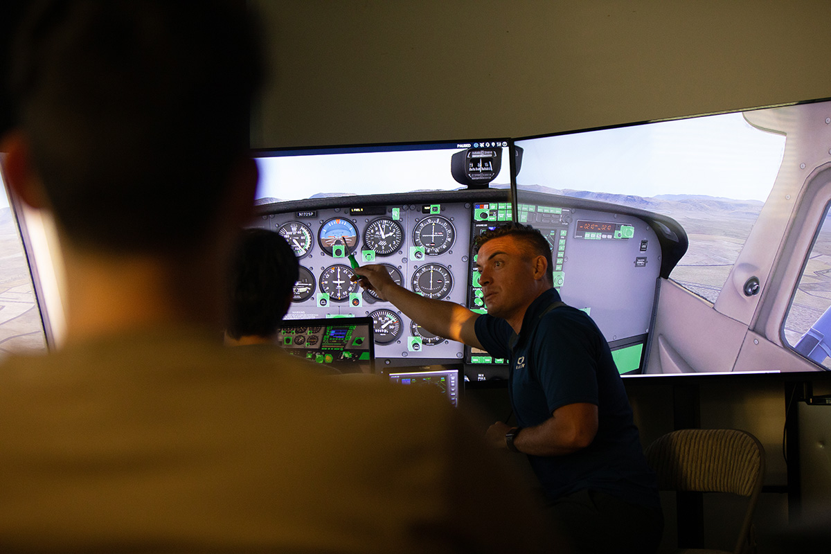 Aviation Science instructor in front of control panel