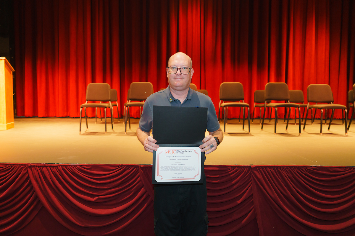 Nicolas holding his certificate