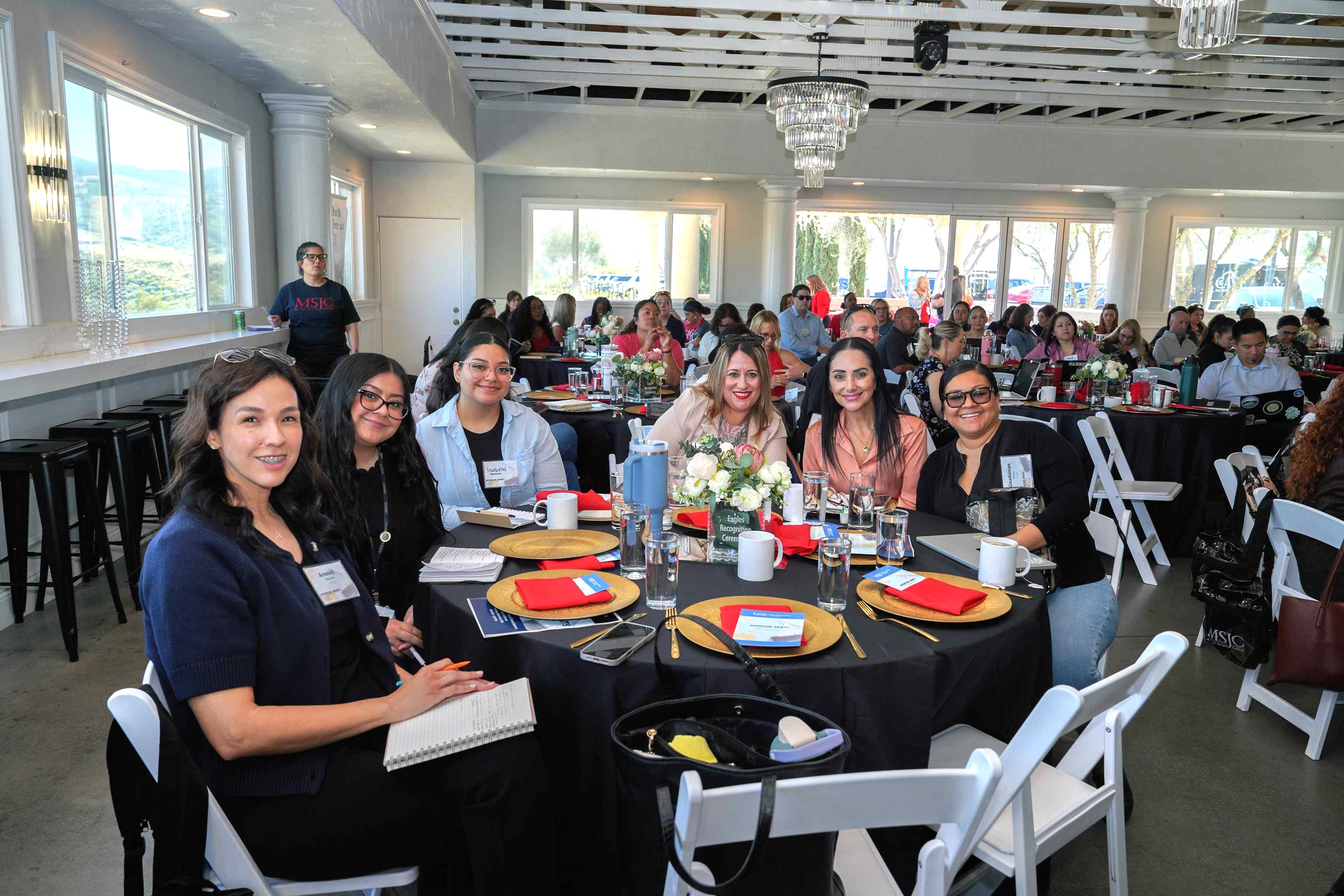 People sitting at a table during the k-12 summit