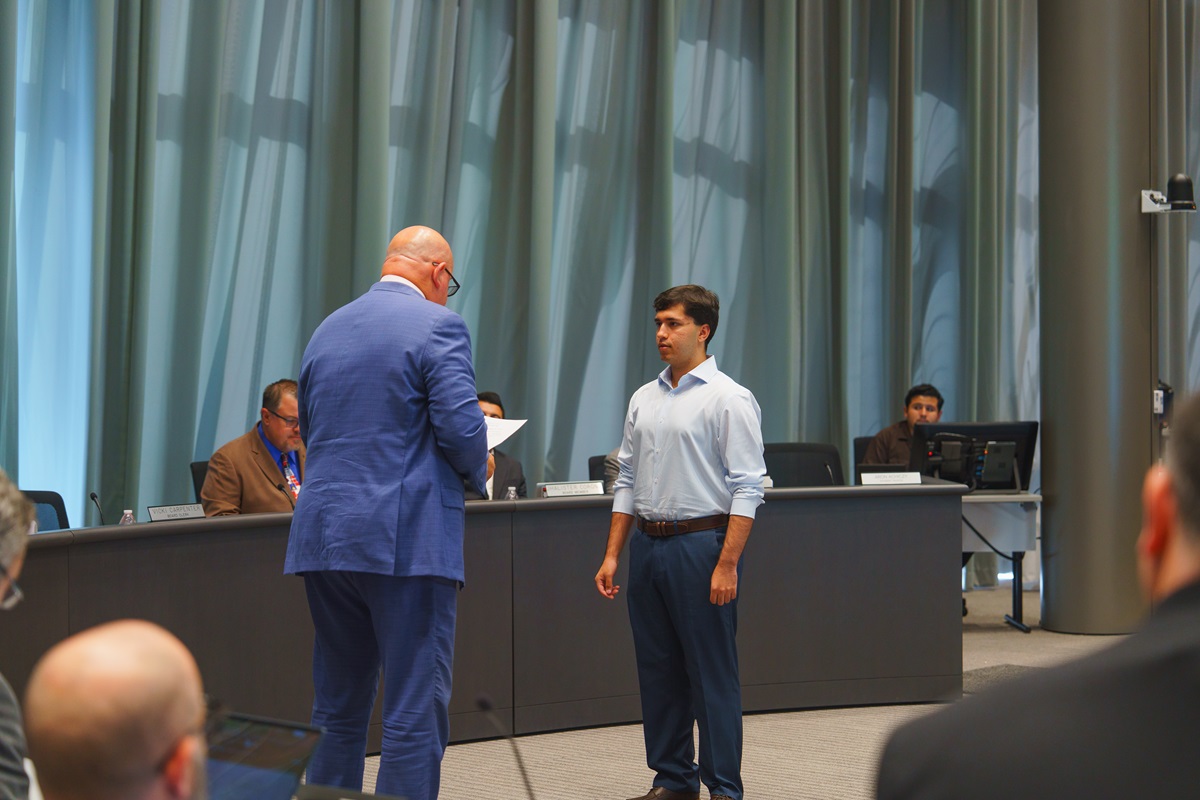 Roger Schultz administers the oath of office to Aron Achiczy