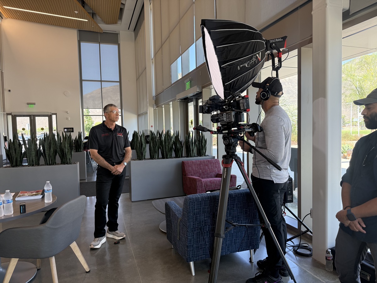Trustee Smith in front of a video camera