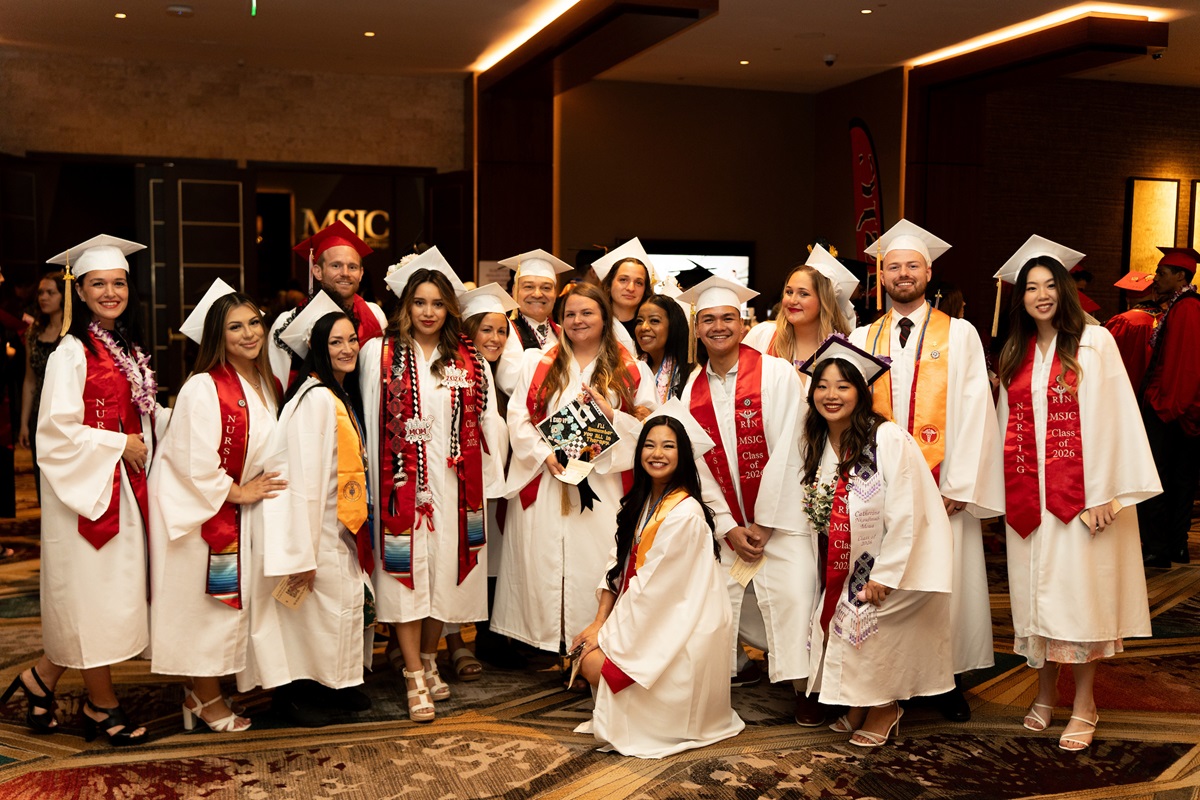 nuring graduates wearing white regalia