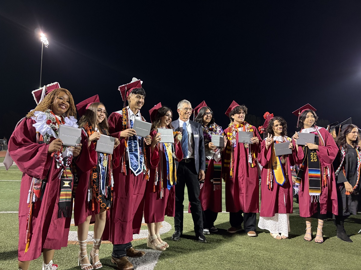 MSJC Trustee Calvin Smith joined the graduates on the field to congratulate them